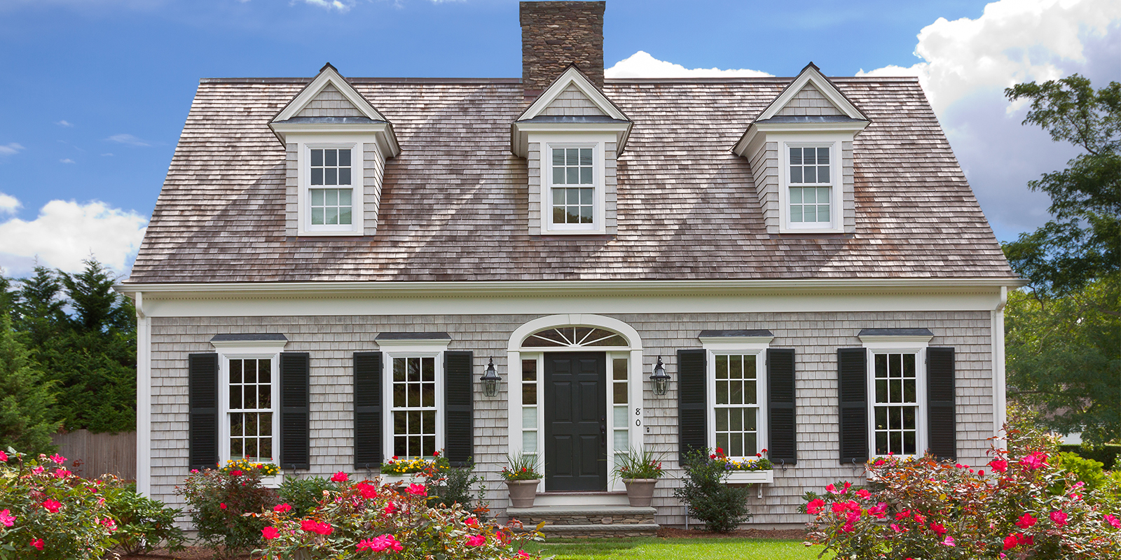 New England single-family home with landscaped front yard